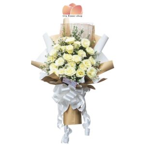 2 dozen white roses bouquet wrap in a white+gold wrapper