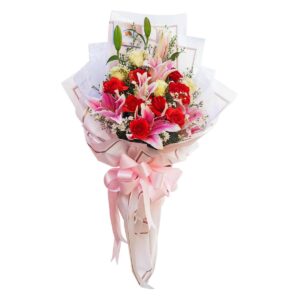 A bouquet of red roses, white roses, and pink stargazer lilies, accented with white filler flowers, wrapped in elegant white and pink paper, and tied with a large pink ribbon