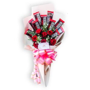 Bouquet of red roses and Hershey's chocolates with pink ribbon wrapping