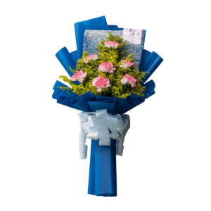 A hand-tied bouquet of soft pink carnations accented with yellow filler flowers called golden rad, elegantly wrapped in deep blue paper and finished with a white ribbon bow.