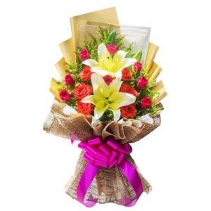 Fresh white lily and red pink rose bouquet wrapped in premium gold paper with abaca